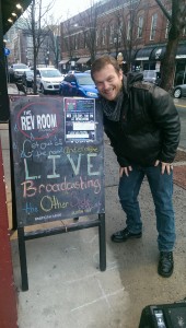 Mike is happy to see the Revolution's sandwich board with our show on it!